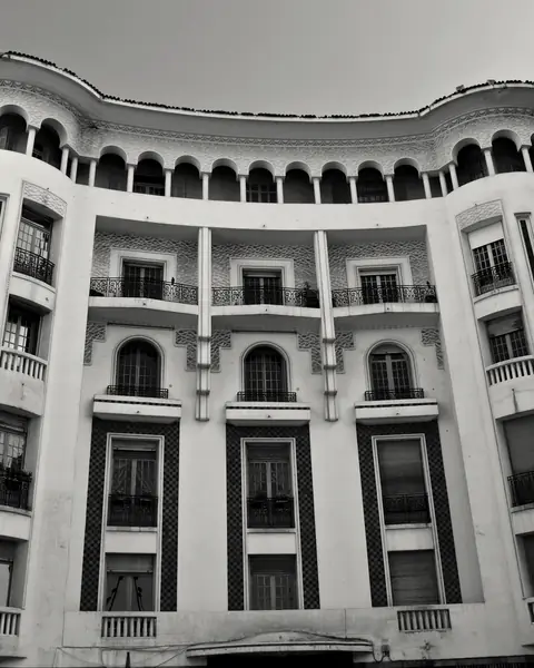 Curved white façade crowned with arcades